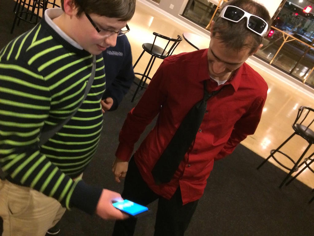 Awesome Inc Academy programming students shows iPhone app to Brian Raney