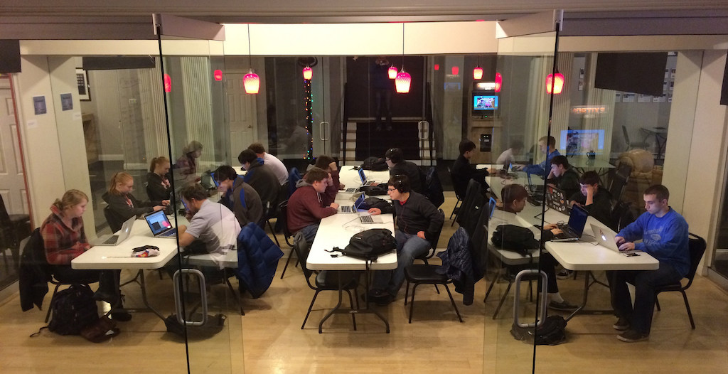 Awesome Inc Academy students working on programming projects with instructors